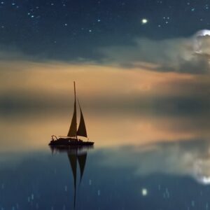 A sea of peace with a small sail boat reflecting a sunrise; restoring your soul